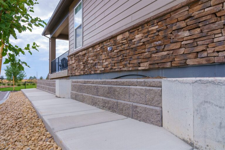 Block retaining wall and concrete walk along a new home in Aurora, CO