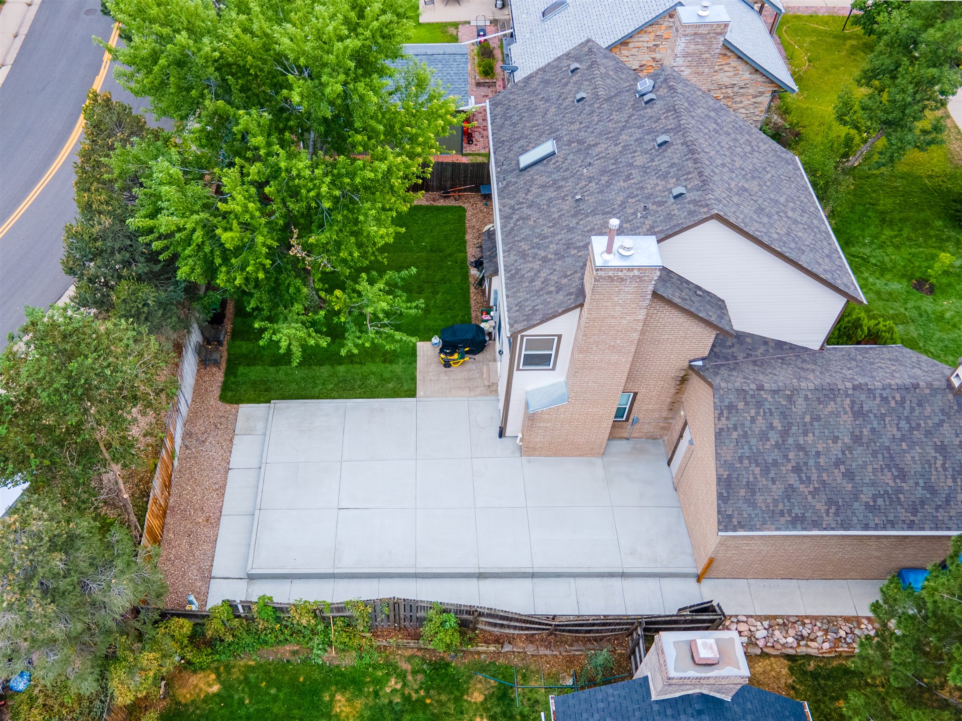 Aerial view of a large concrete patio and new lawn