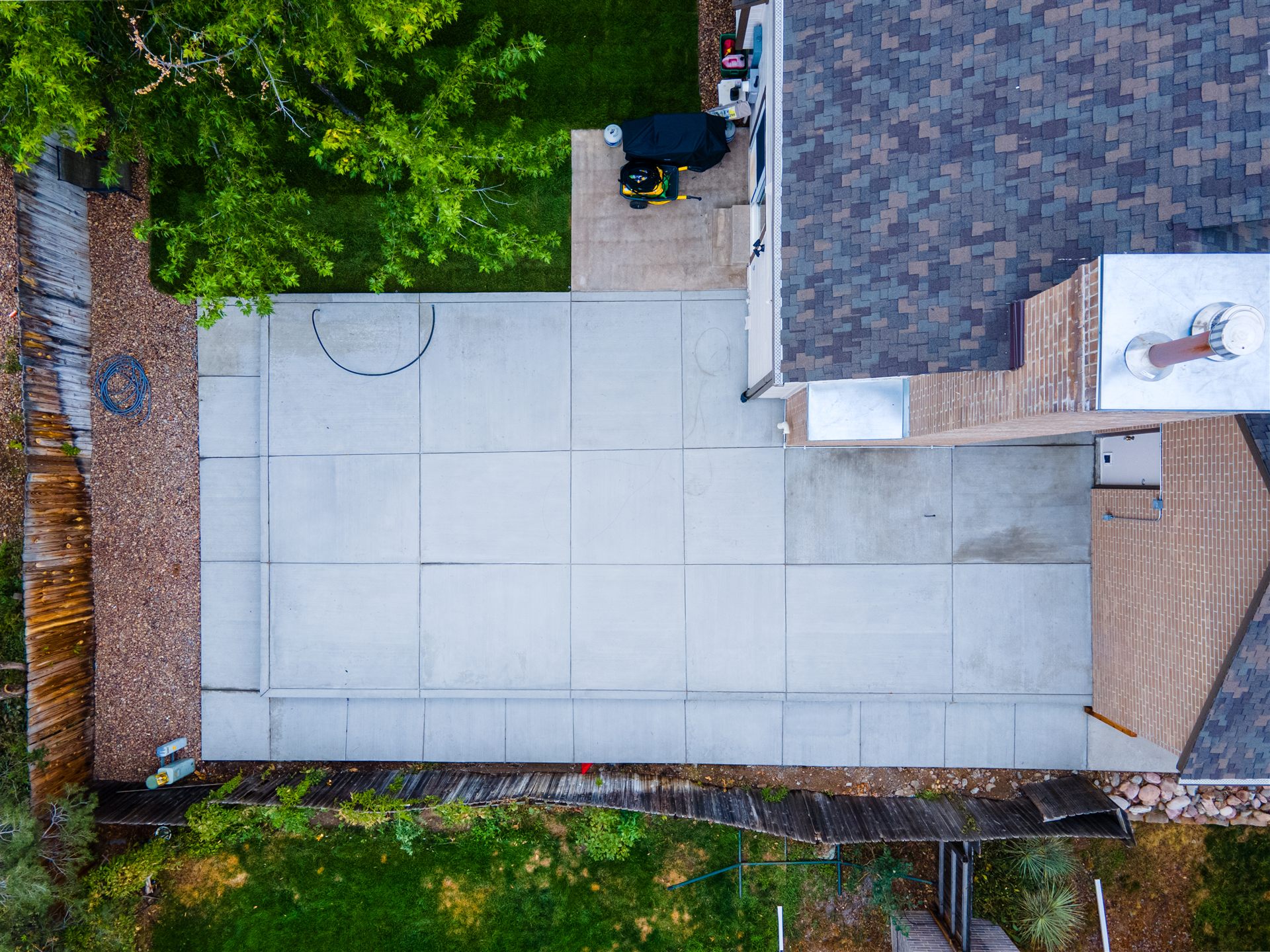 Overhead view of a concrete patio with control joints