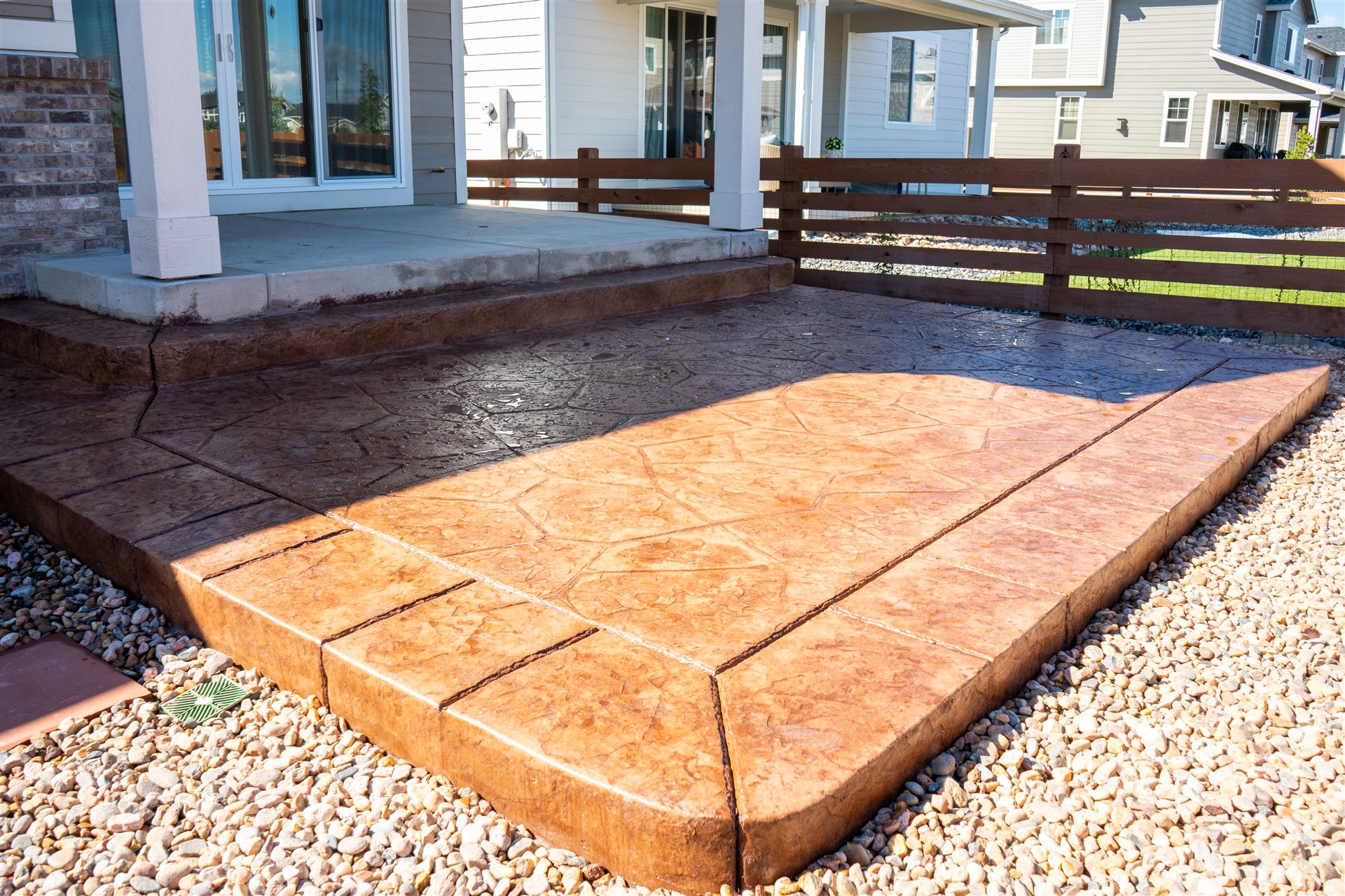 Colored stamped concrete patio extension with a border in Brighton, CO