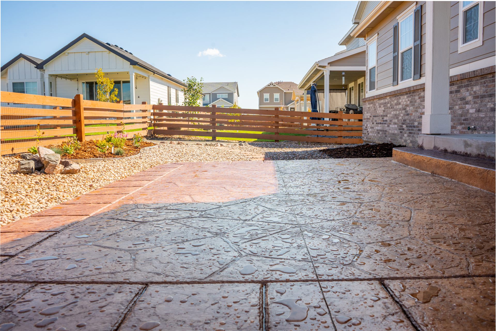 Stamped concrete patio along the side of a new home