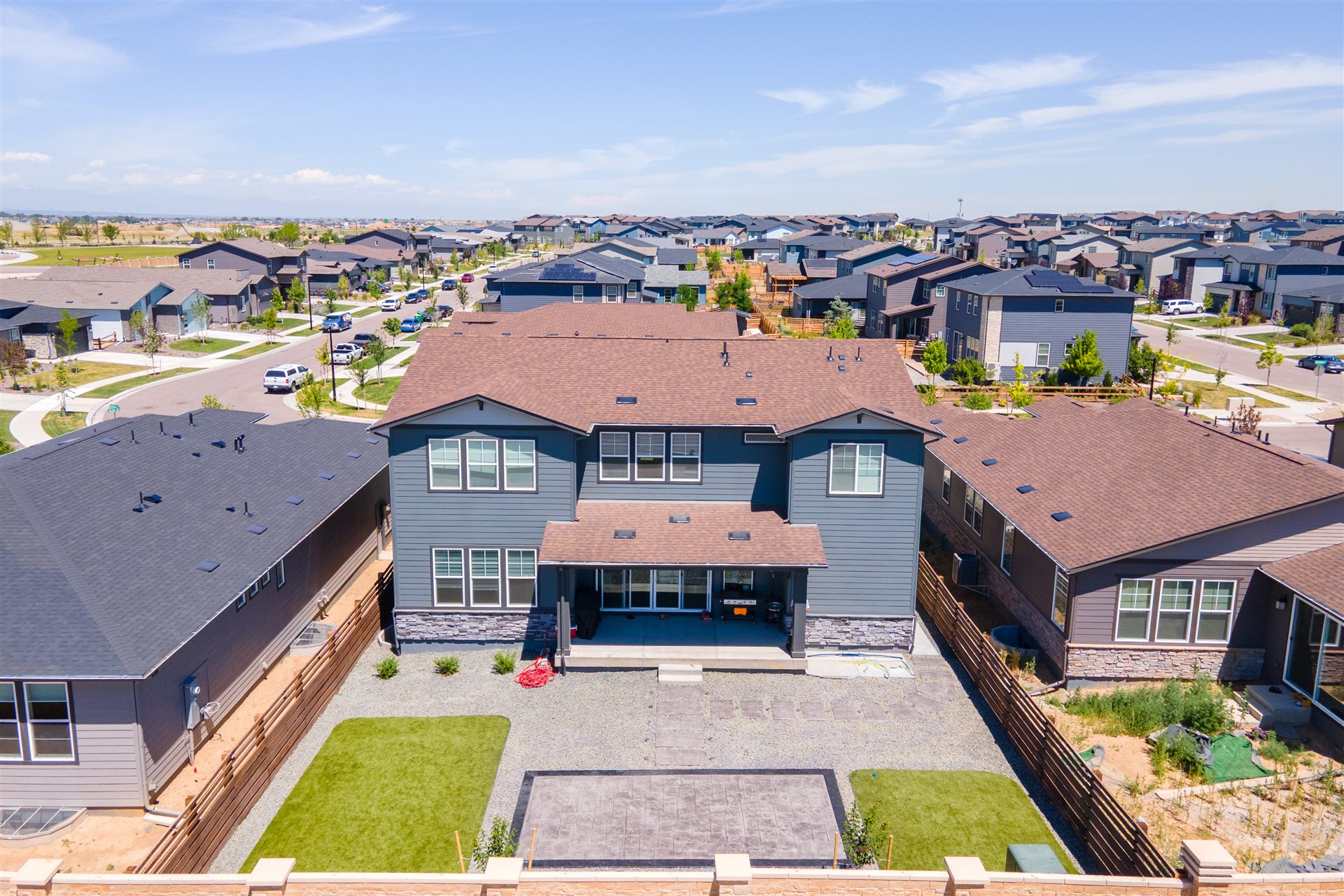 Aerial view of a Broomfield backyard with a stamped patio, turf and rock