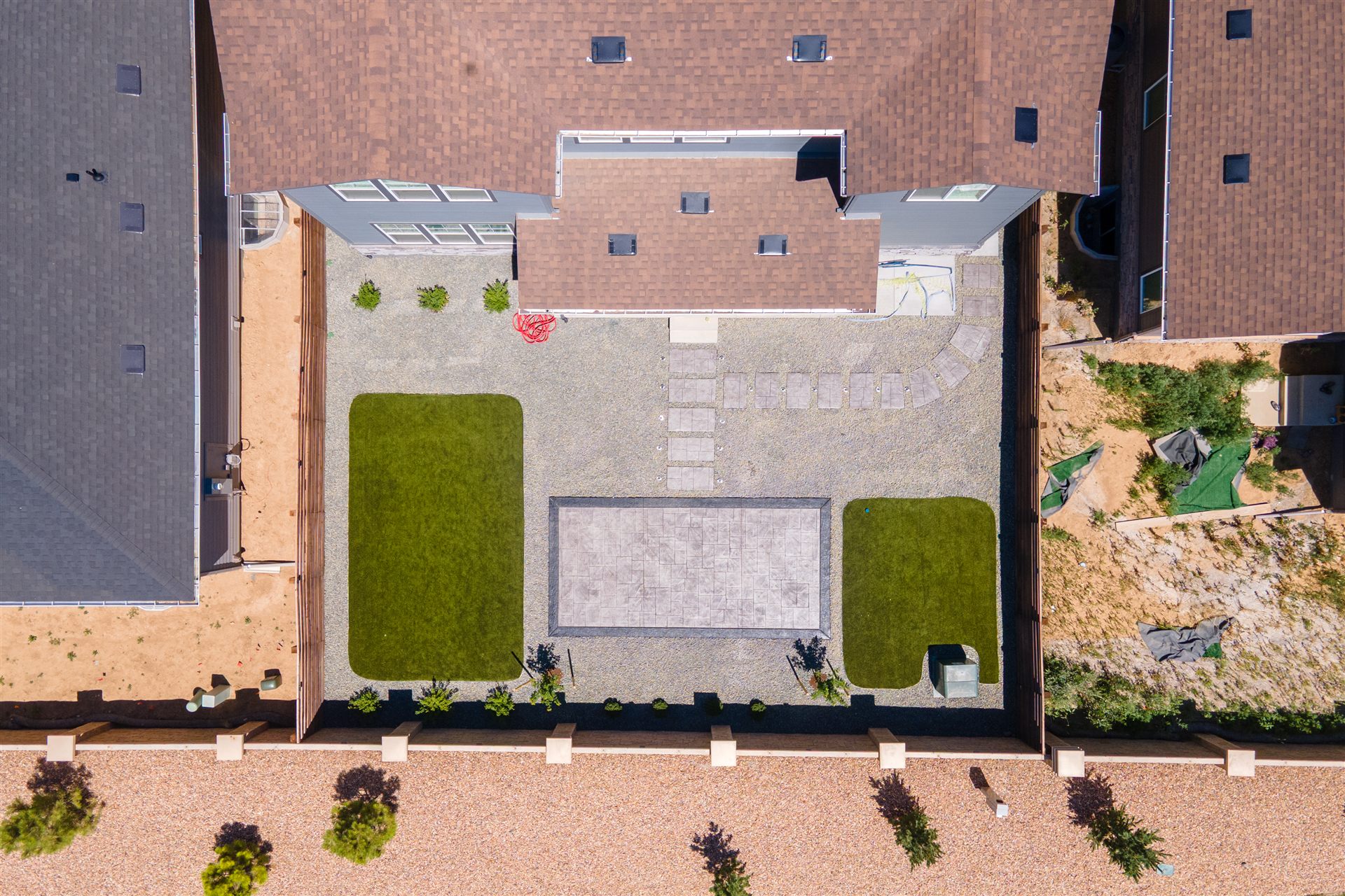 Overhead view of a stamped patio between two turf panels