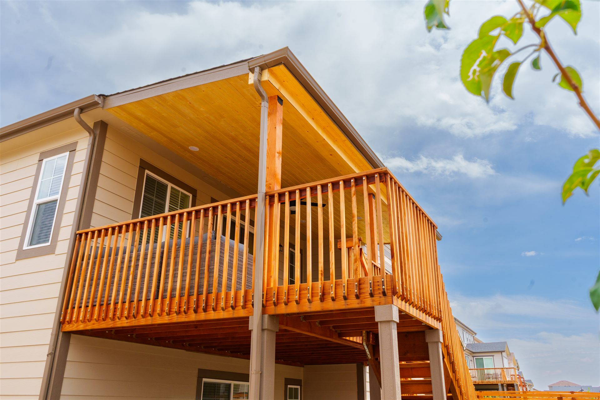 Elevated covered deck with stained wood railings in Castle Rock, CO
