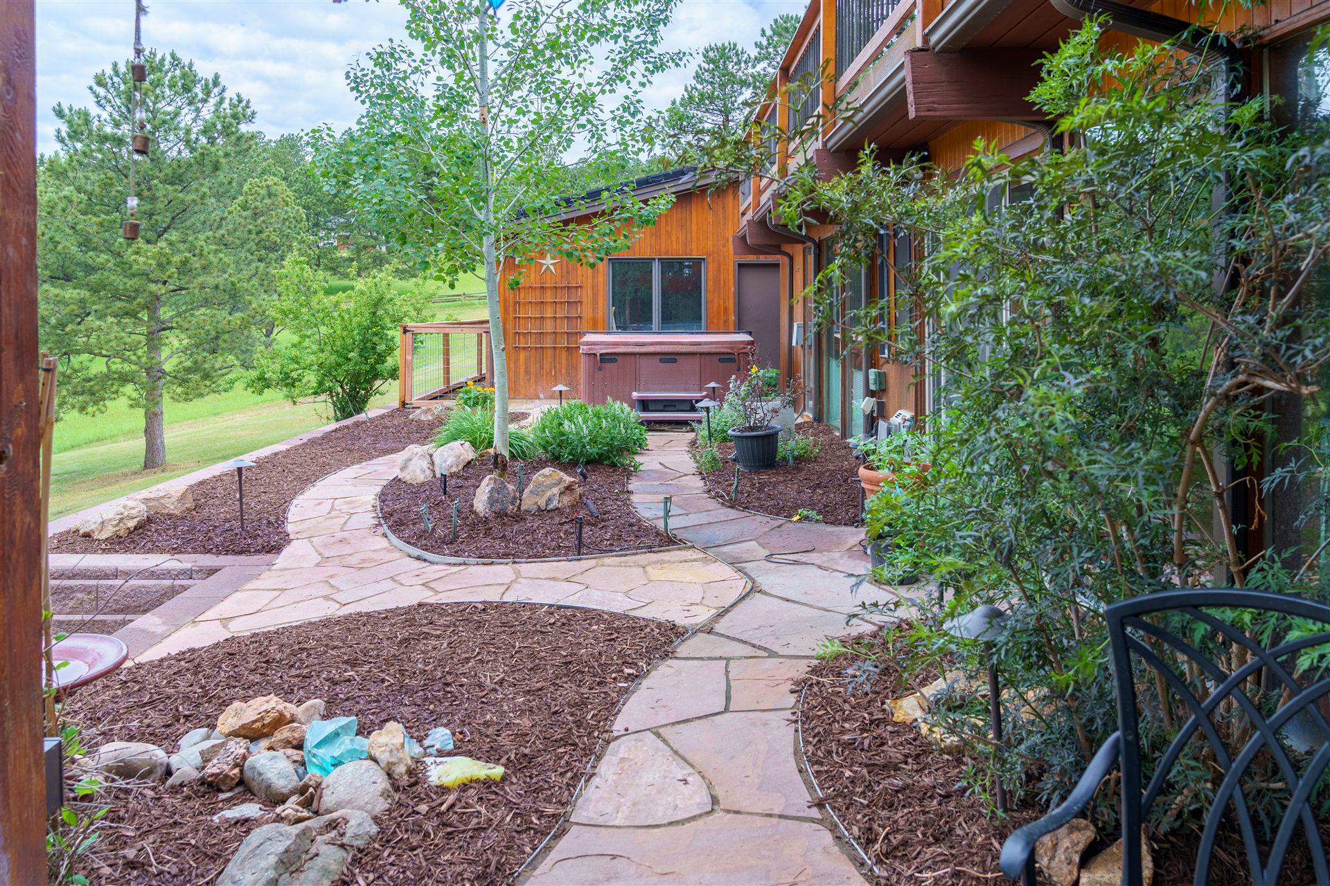 Curving flagstone path with landscape lighting in Castle Rock