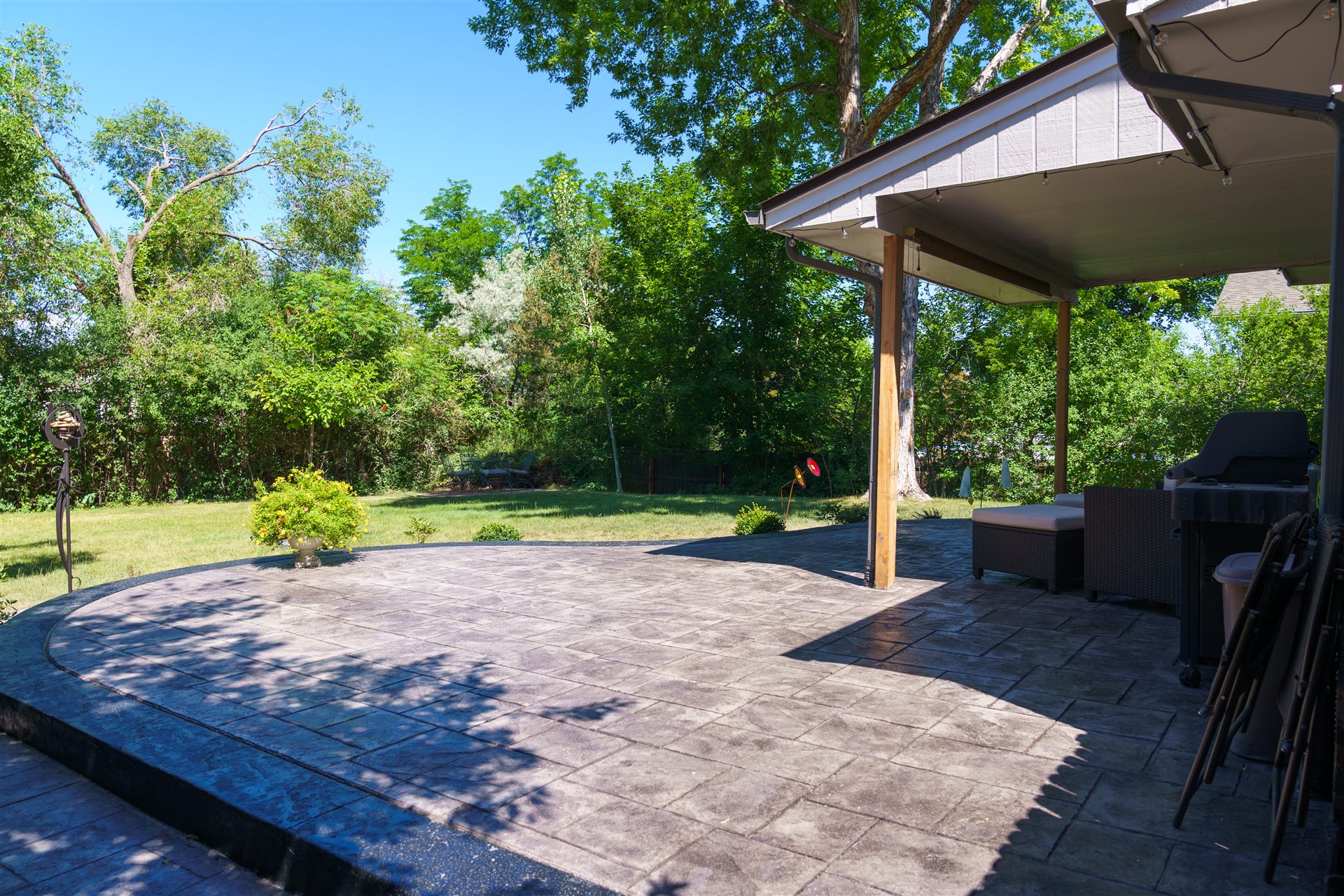Stamped concrete patio next to a covered patio