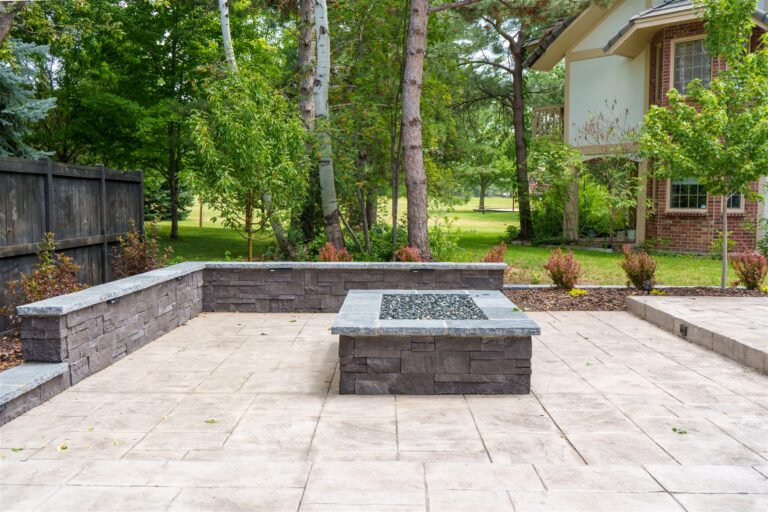 Stone fire pit and seat walls on a stamped concrete patio in Castle Rock, CO