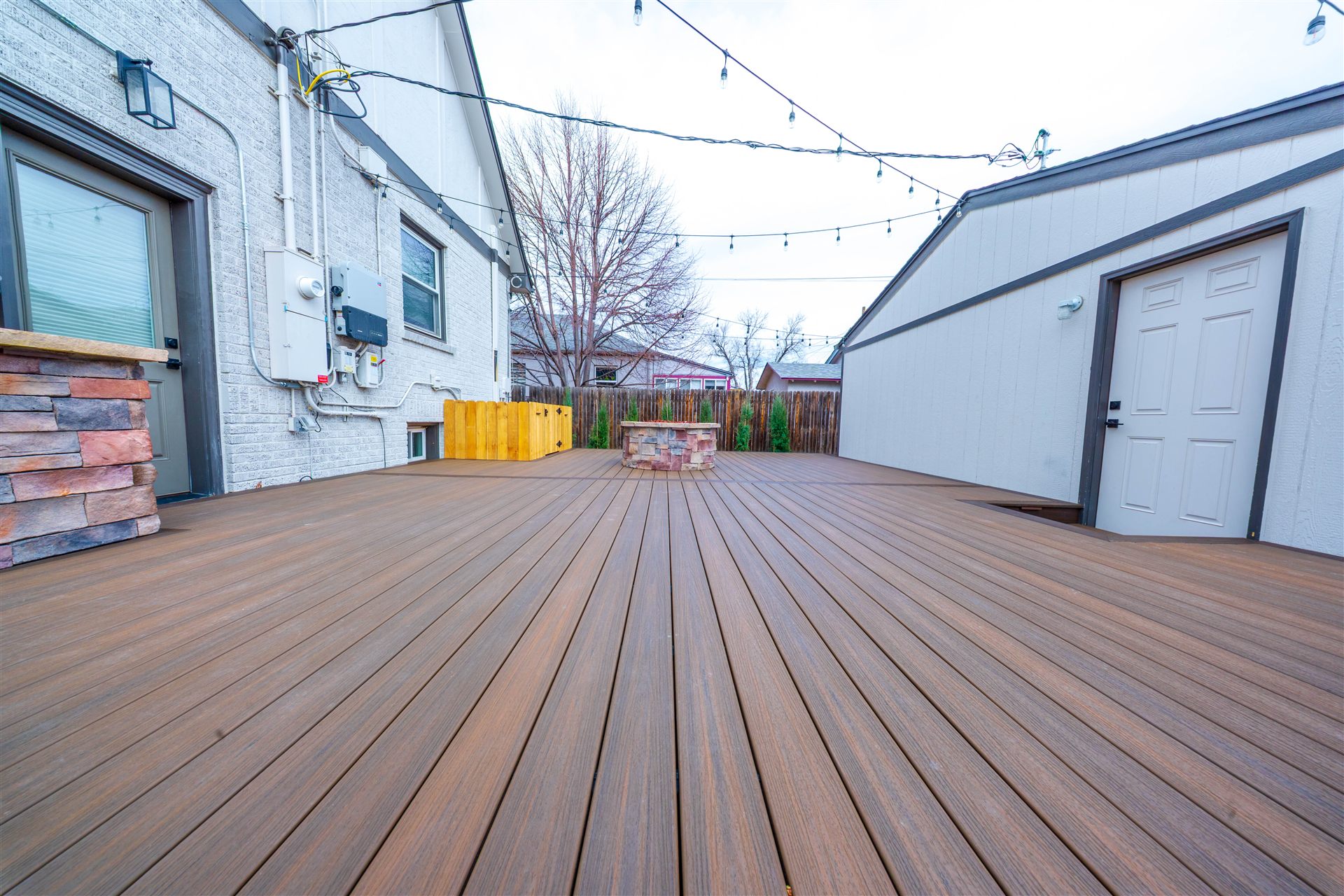 Wide view of a composite deck running from the house to the garage