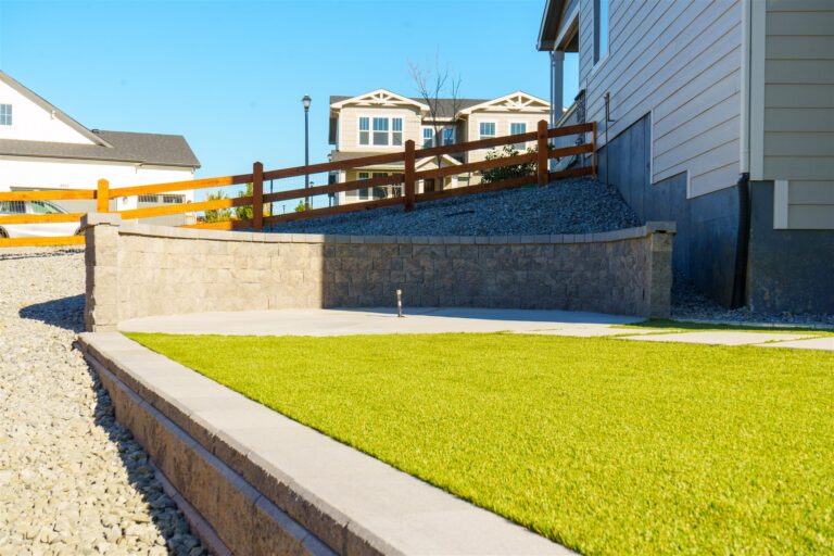 Block retaining wall above a synthetic turf lawn in Centennial, CO