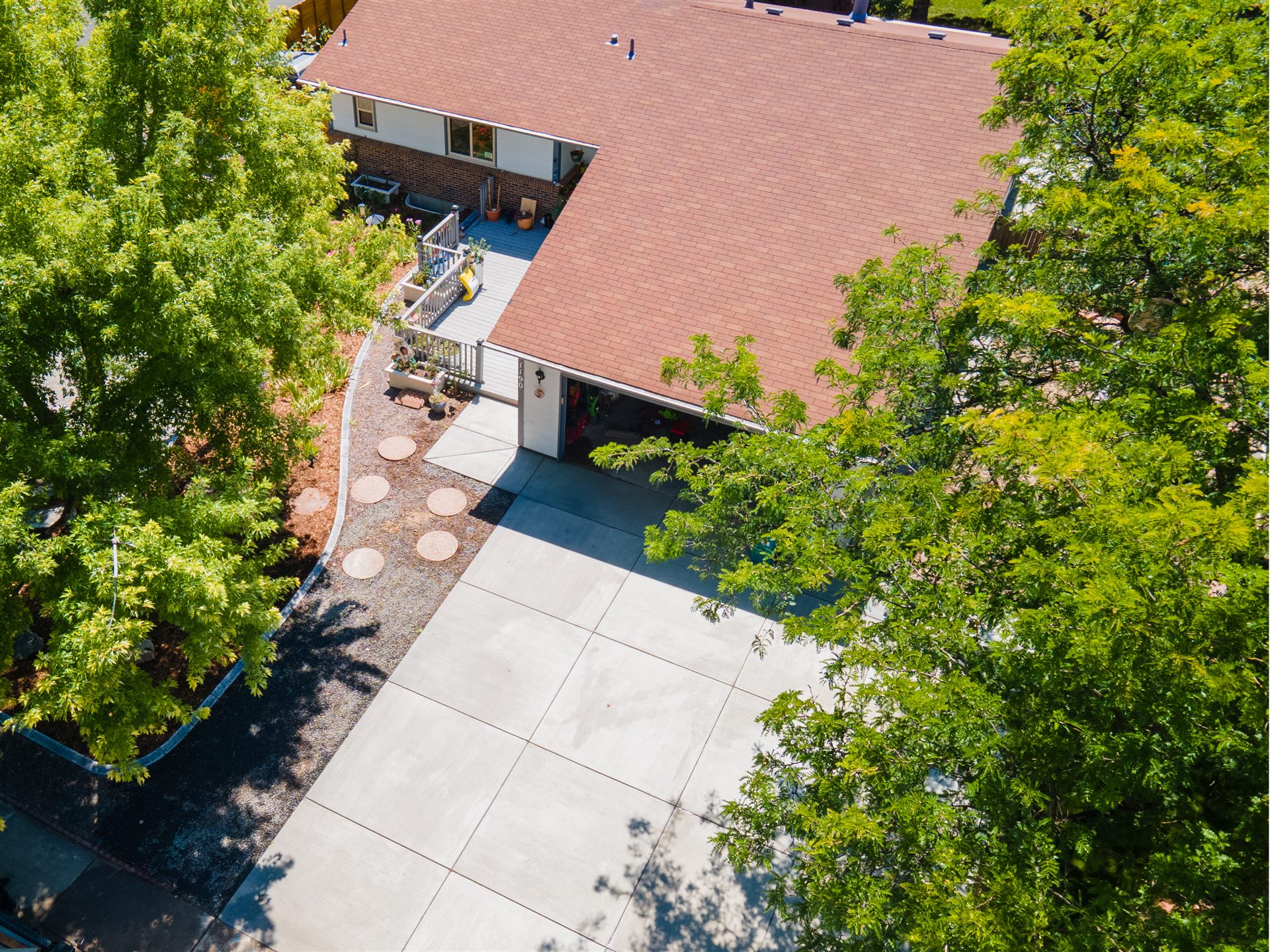 Aerial view of a concrete driveway under mature trees