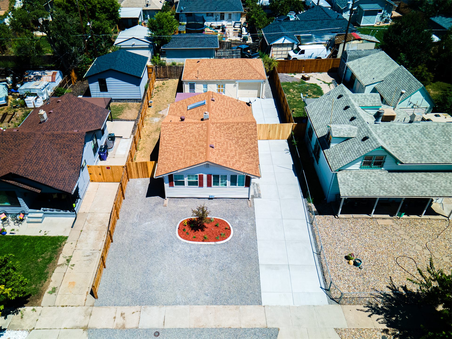 Aerial view of a long concrete driveway and backyard pad