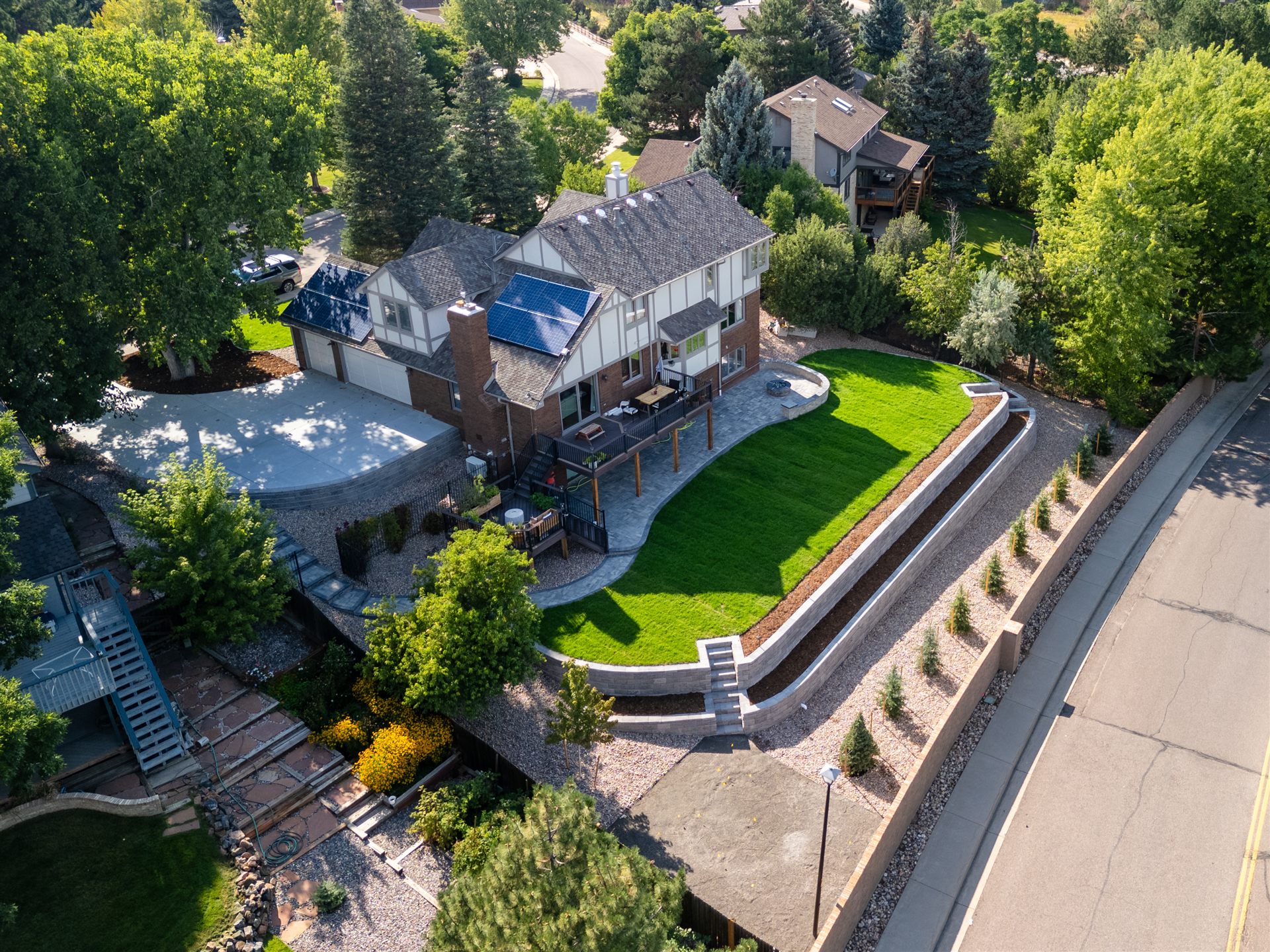 Curved block retaining wall holding a level sod lawn
