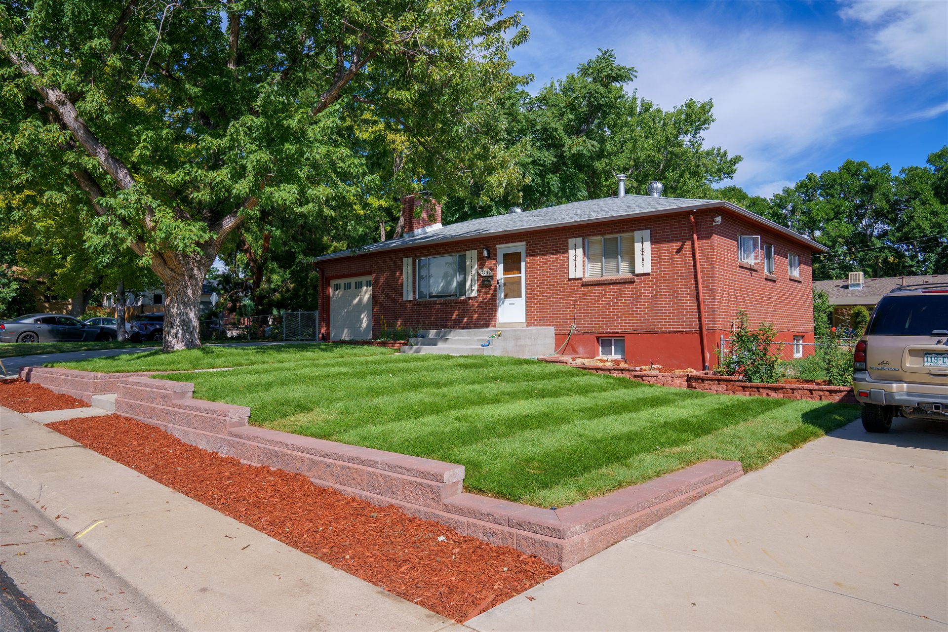 New sod front lawn with a low block wall edge in Lakewood