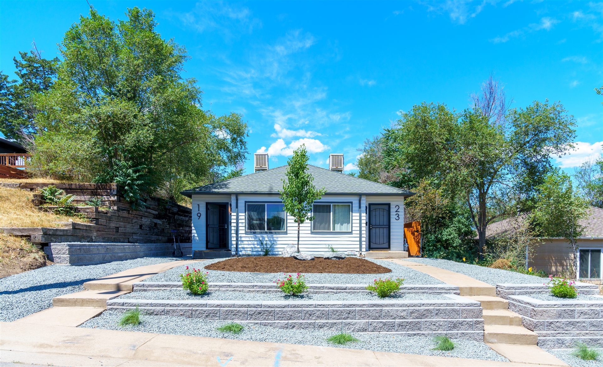 Terraced front yard with tiered block retaining walls and steps in Lakewood, CO