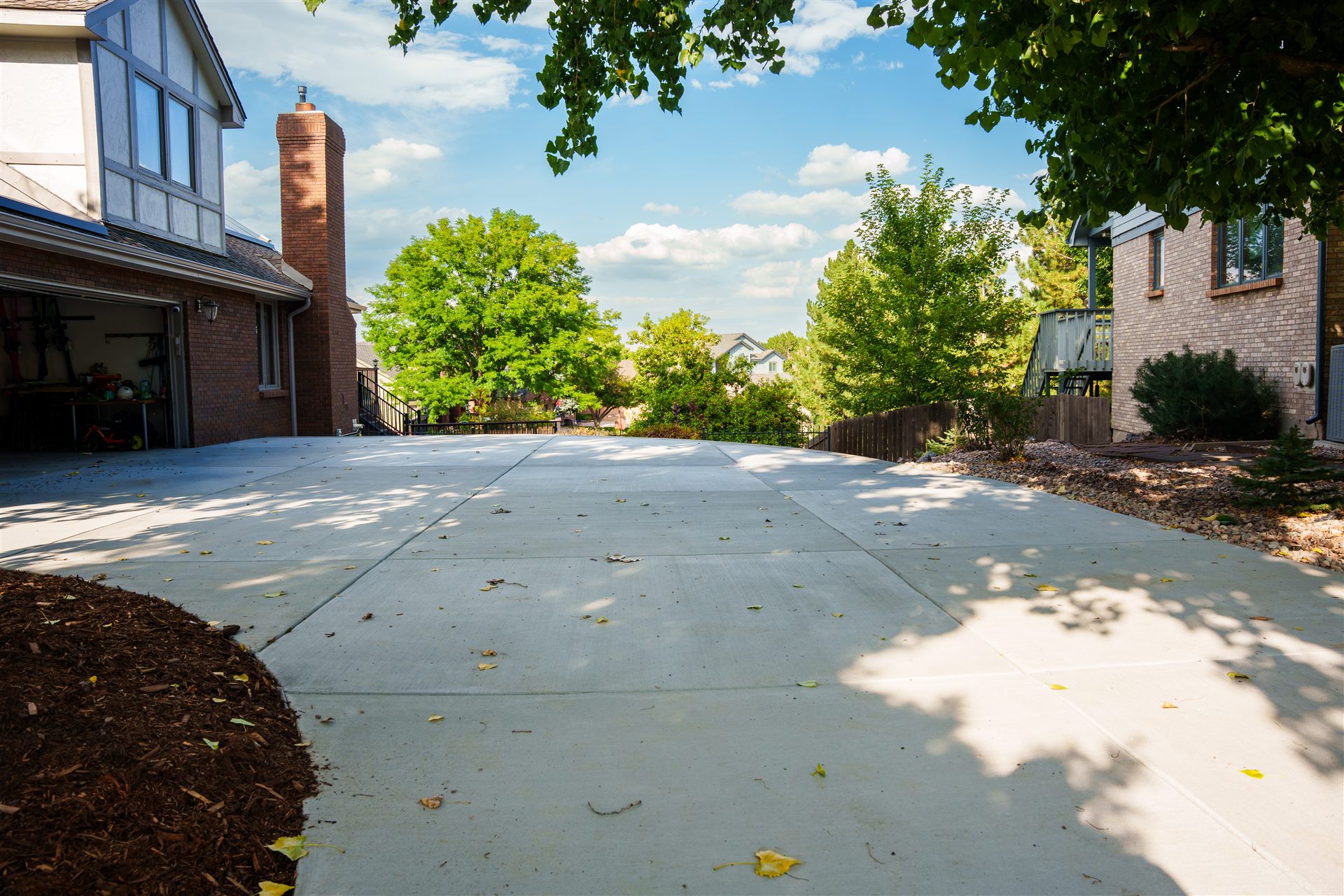 New concrete driveway at a brick home in Littleton