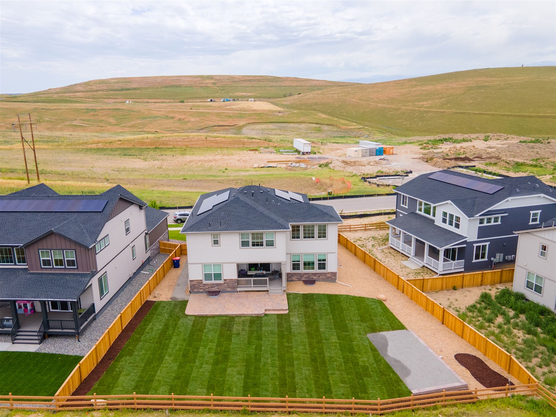 Aerial view of a new-build backyard with fresh sod and a paver patio in Littleton, CO