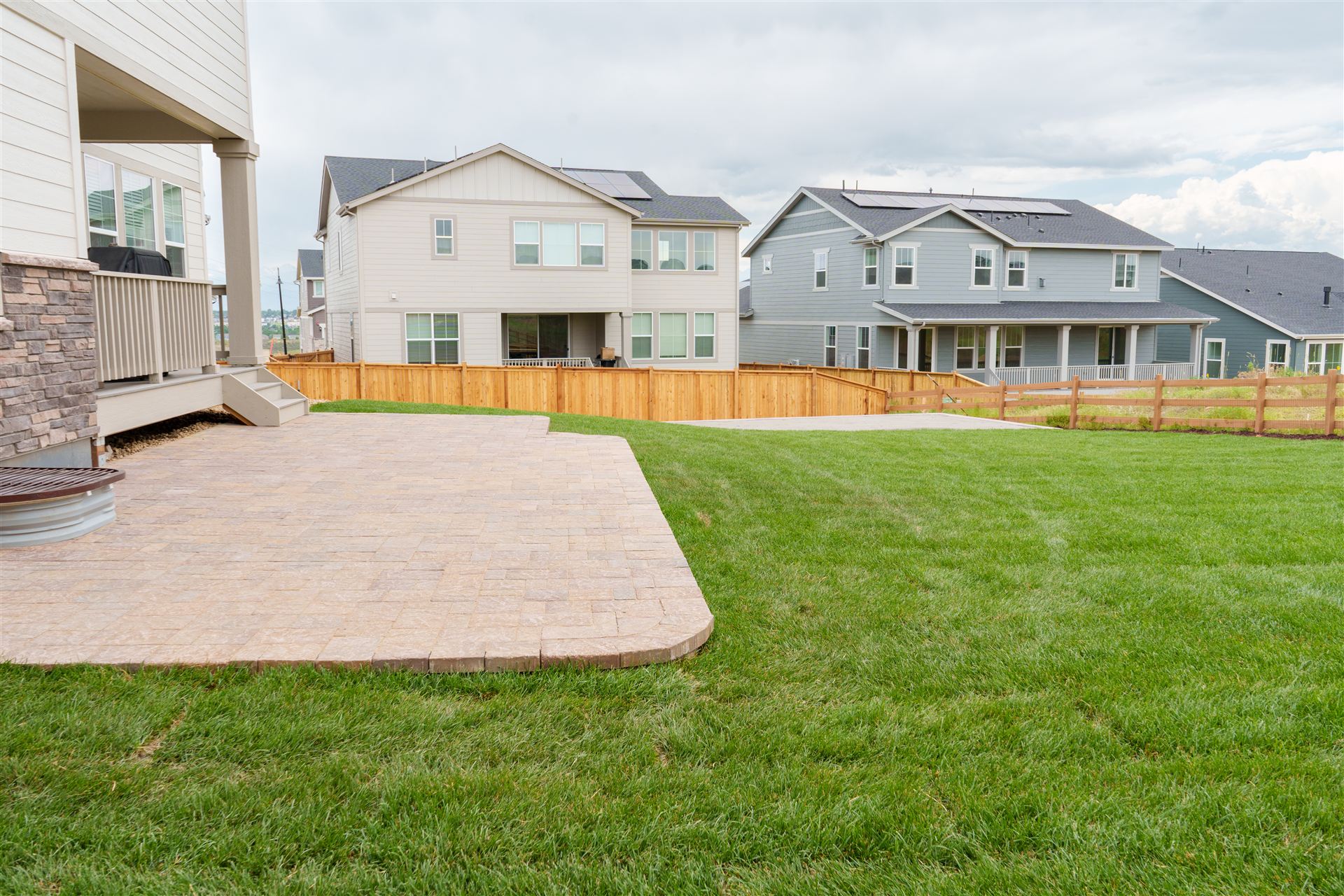 Paver patio with an angled edge next to new sod