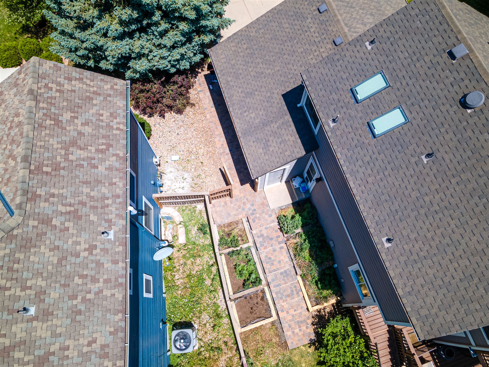 Aerial view of a terraced side yard with a paver walkway in Littleton
