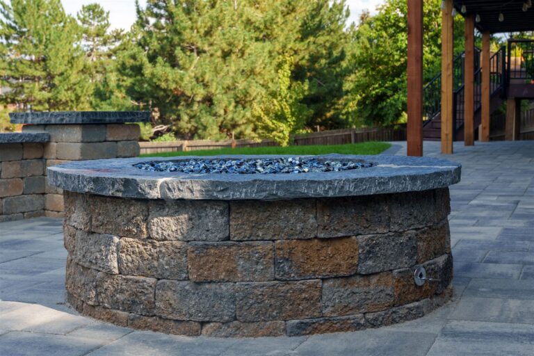 Round stone block fire pit with a stone cap in Littleton, CO