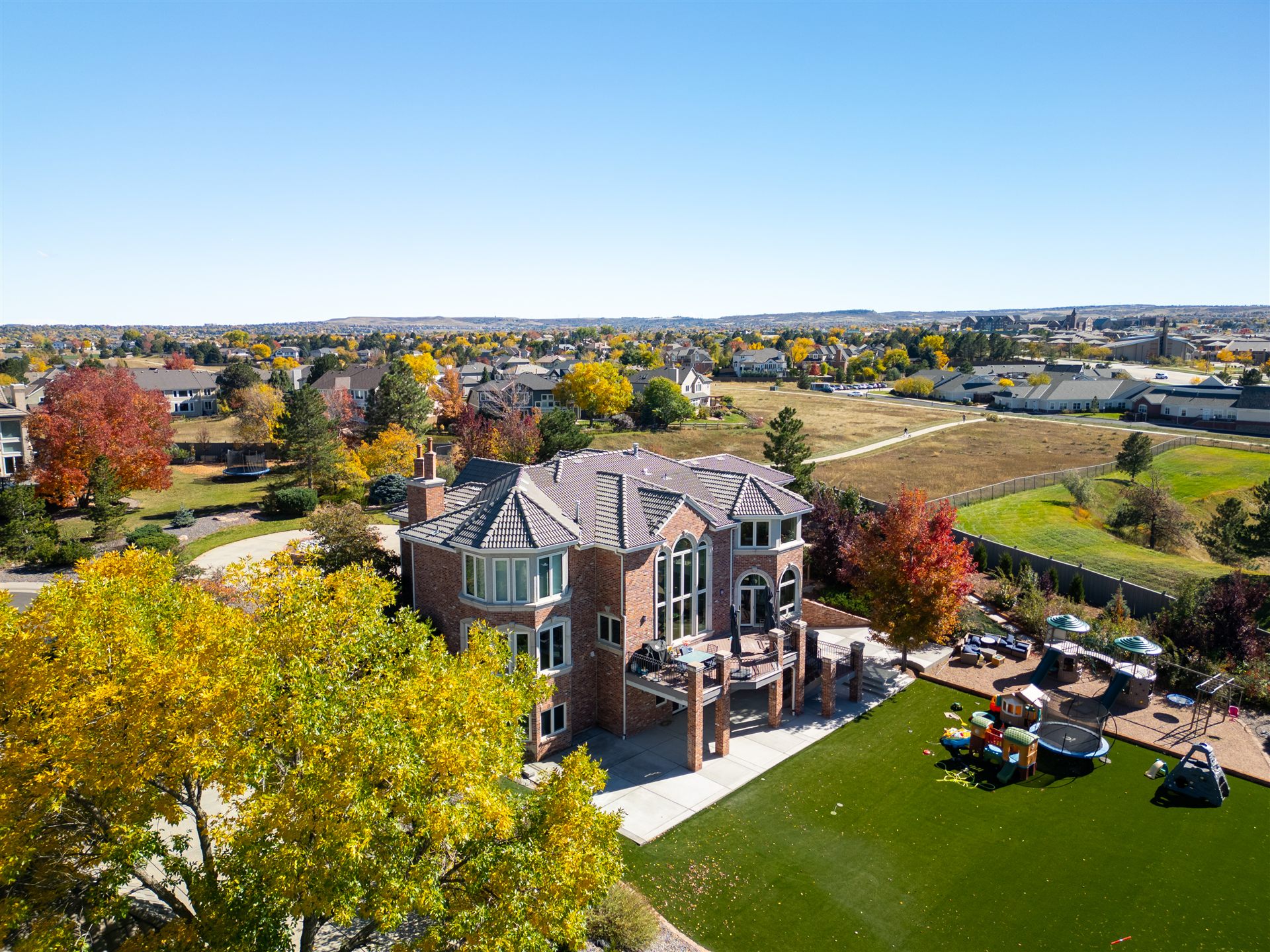 Aerial view of a large Lone Tree home and backyard in the fall