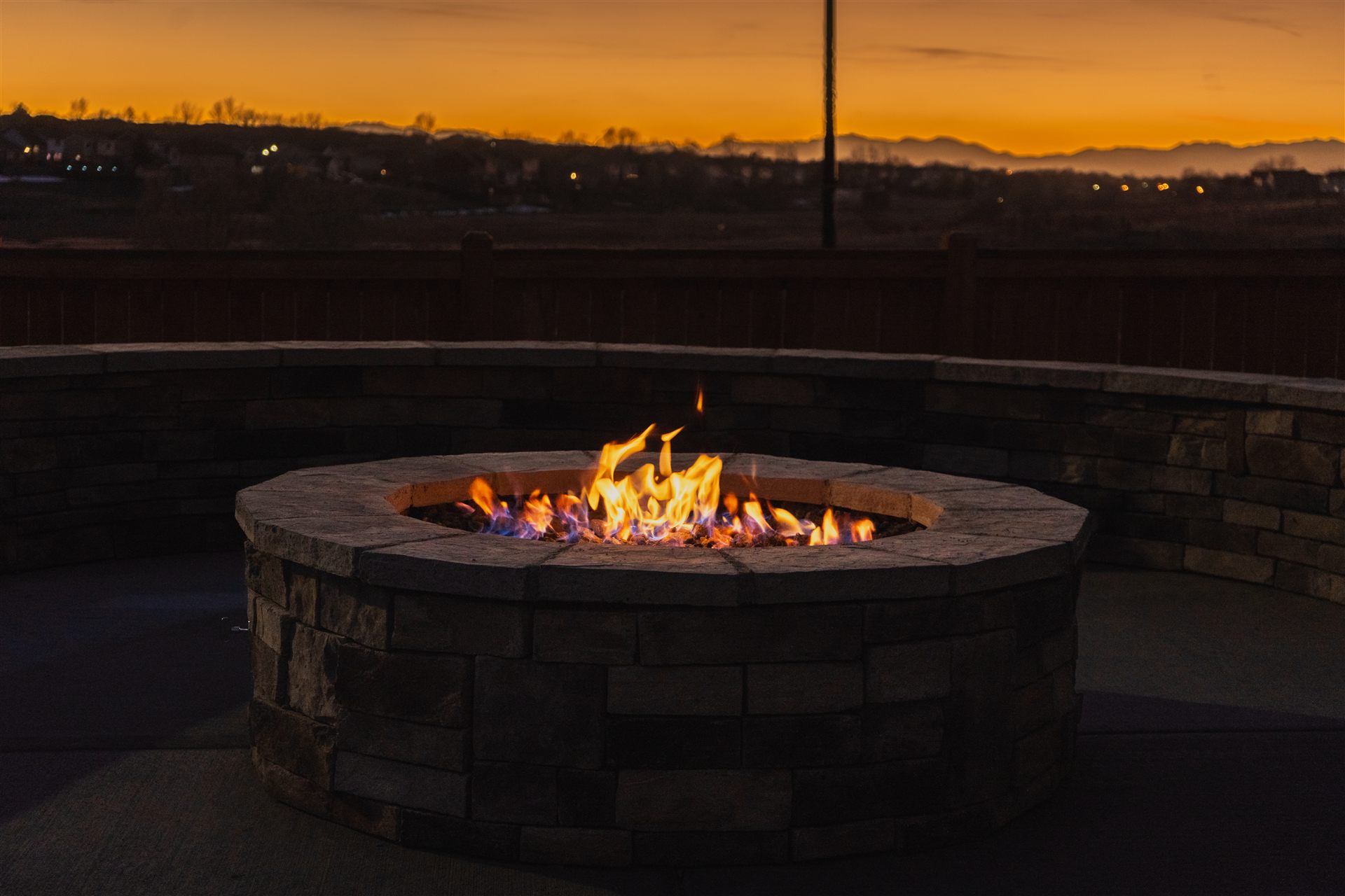 Round stone fire pit at sunset in Lone Tree, CO