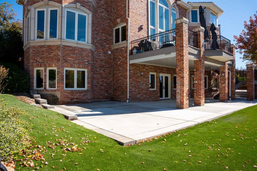 Concrete patio at the walkout level of a large brick home in Lone Tree, CO