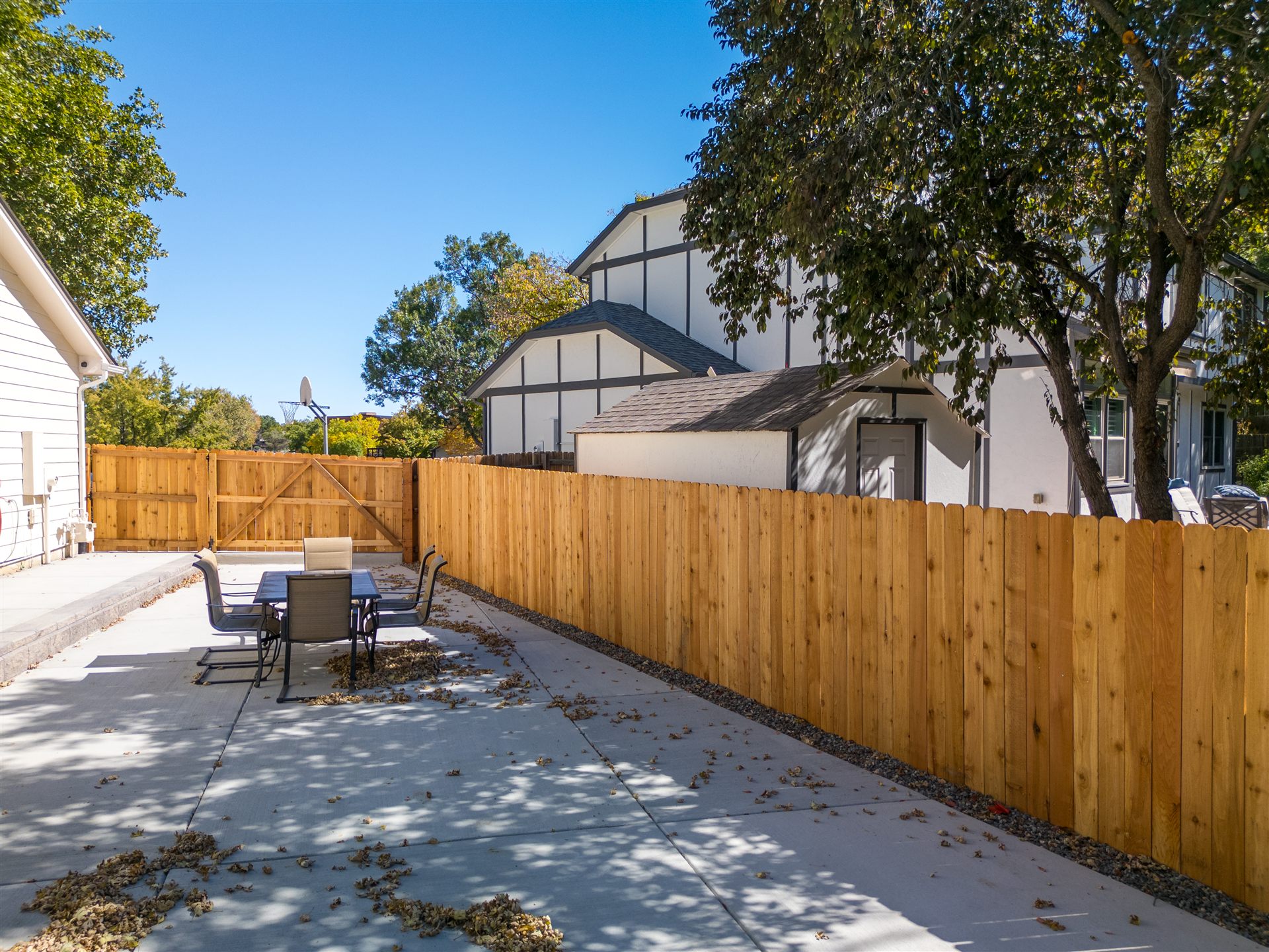 Concrete backyard patio along a new wood fence