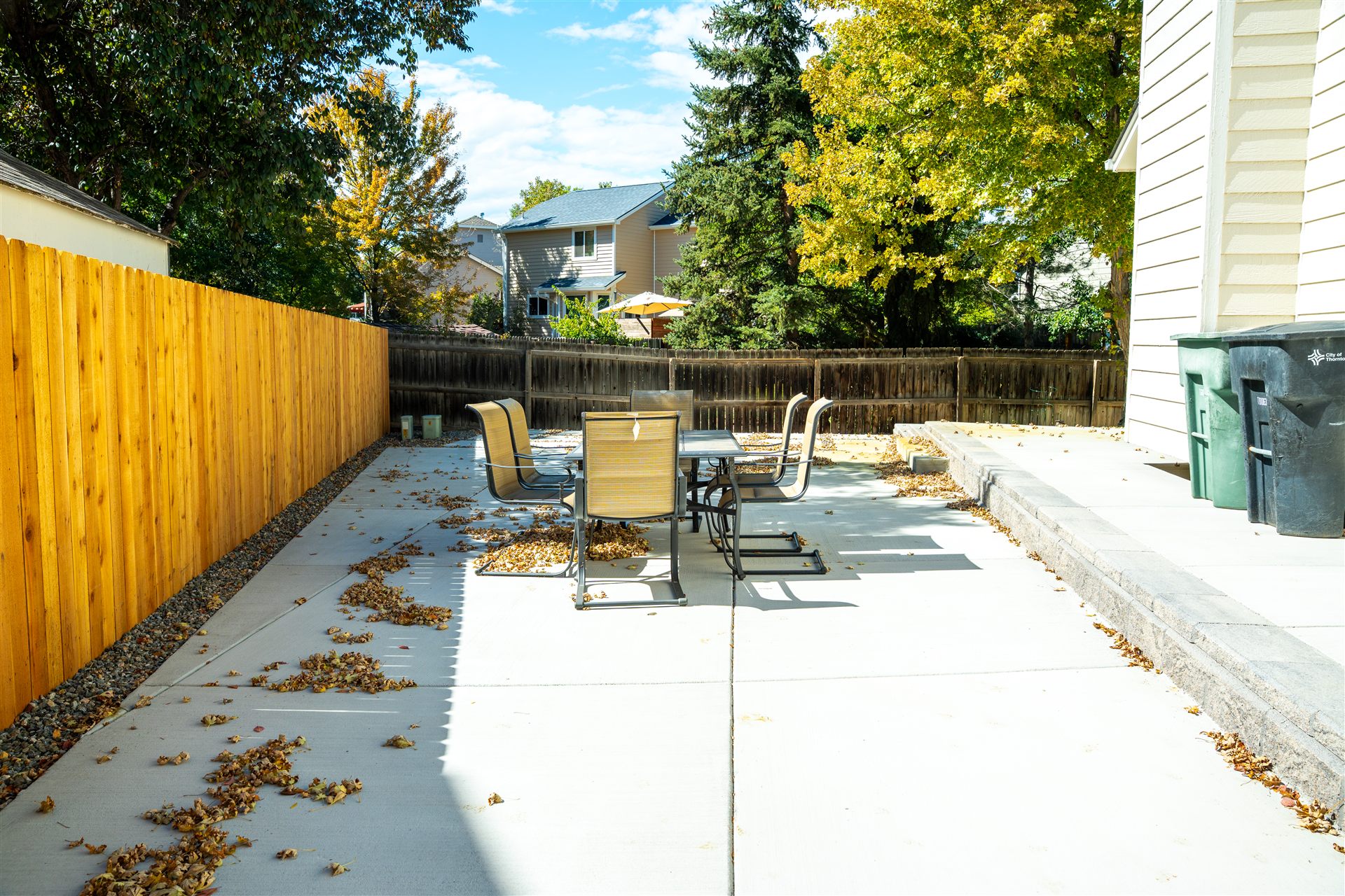 Concrete patio with a cedar fence and dining set in Longmont, CO