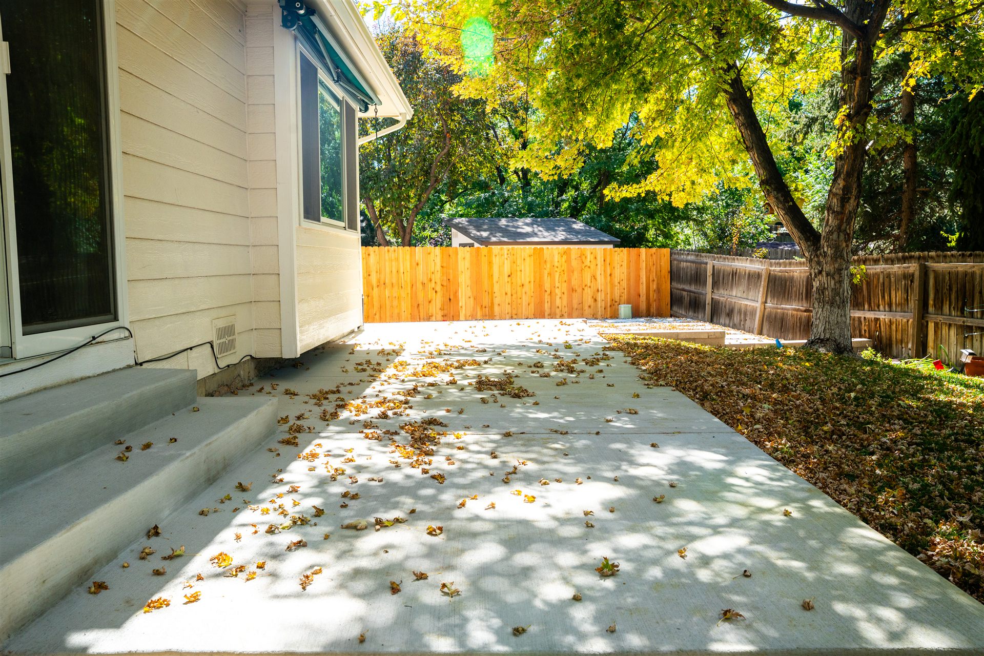 Concrete side yard with steps from the house