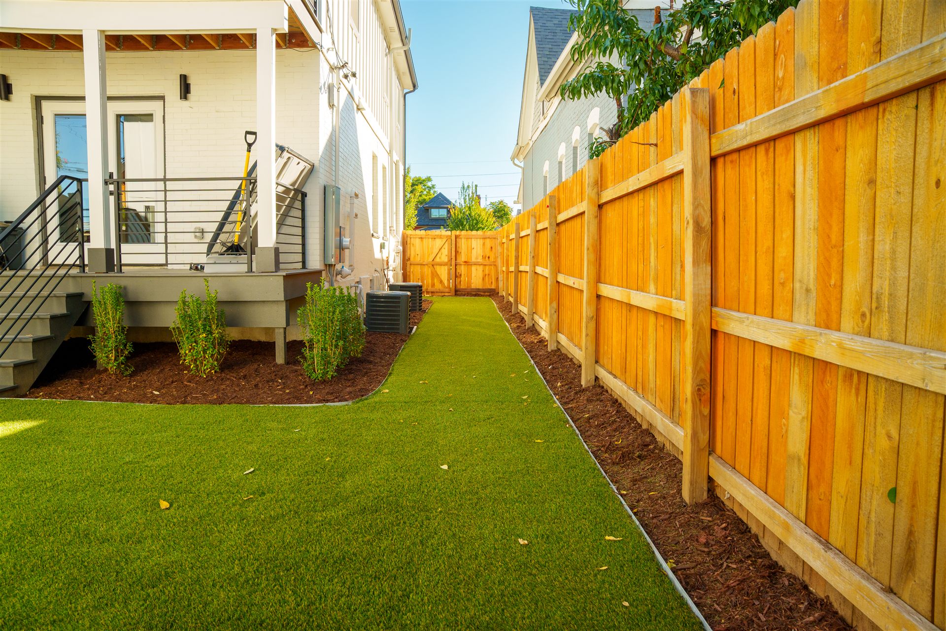 Synthetic turf side yard along a new wood fence