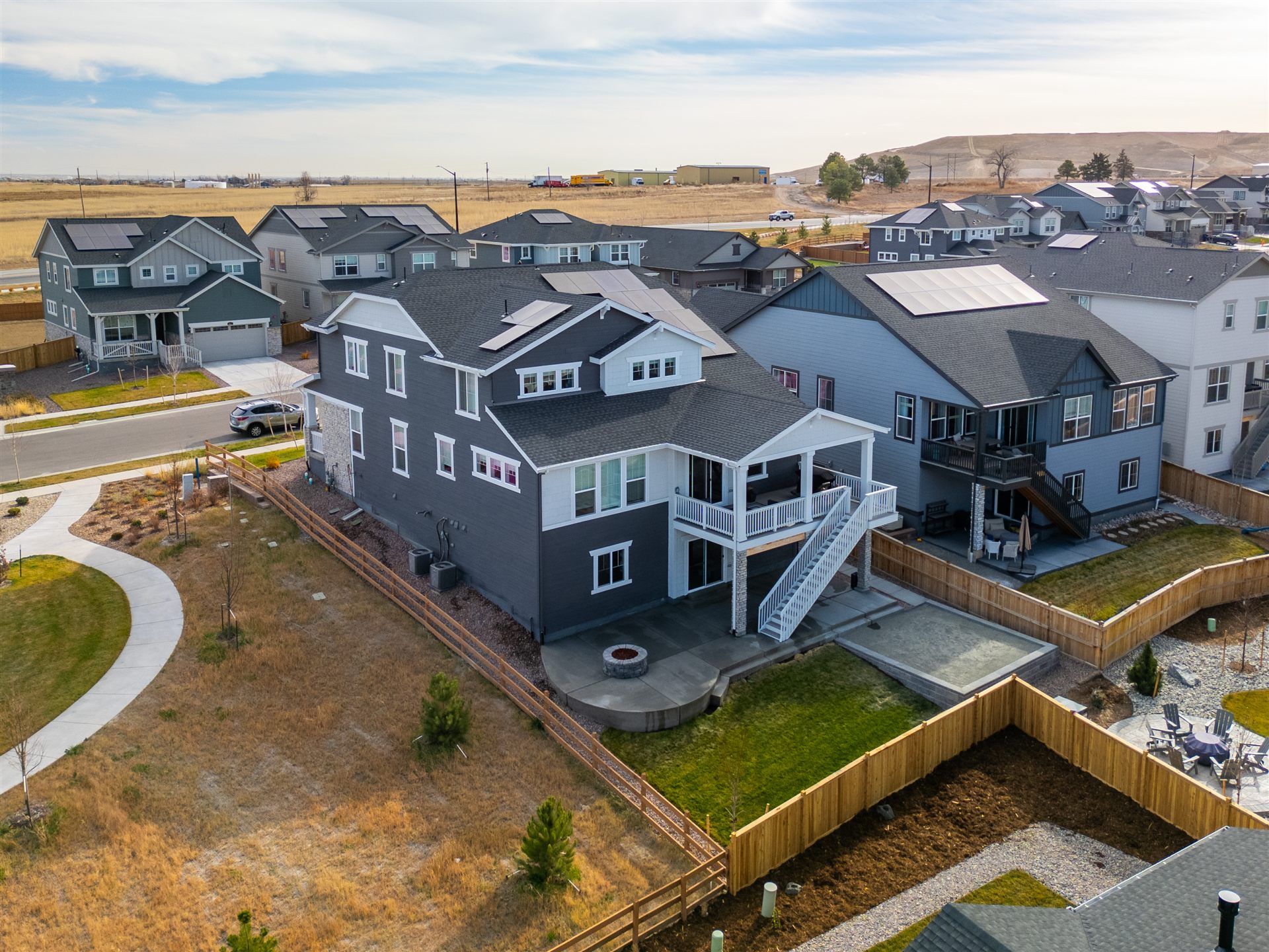 Aerial view of a new Thornton home with a curved patio and fire pit