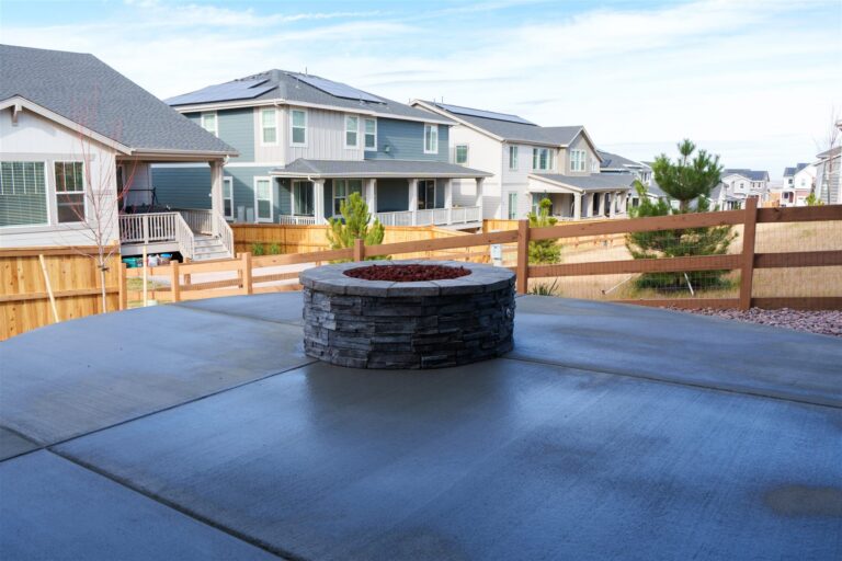 Round stone fire pit on a new concrete patio in Thornton, CO