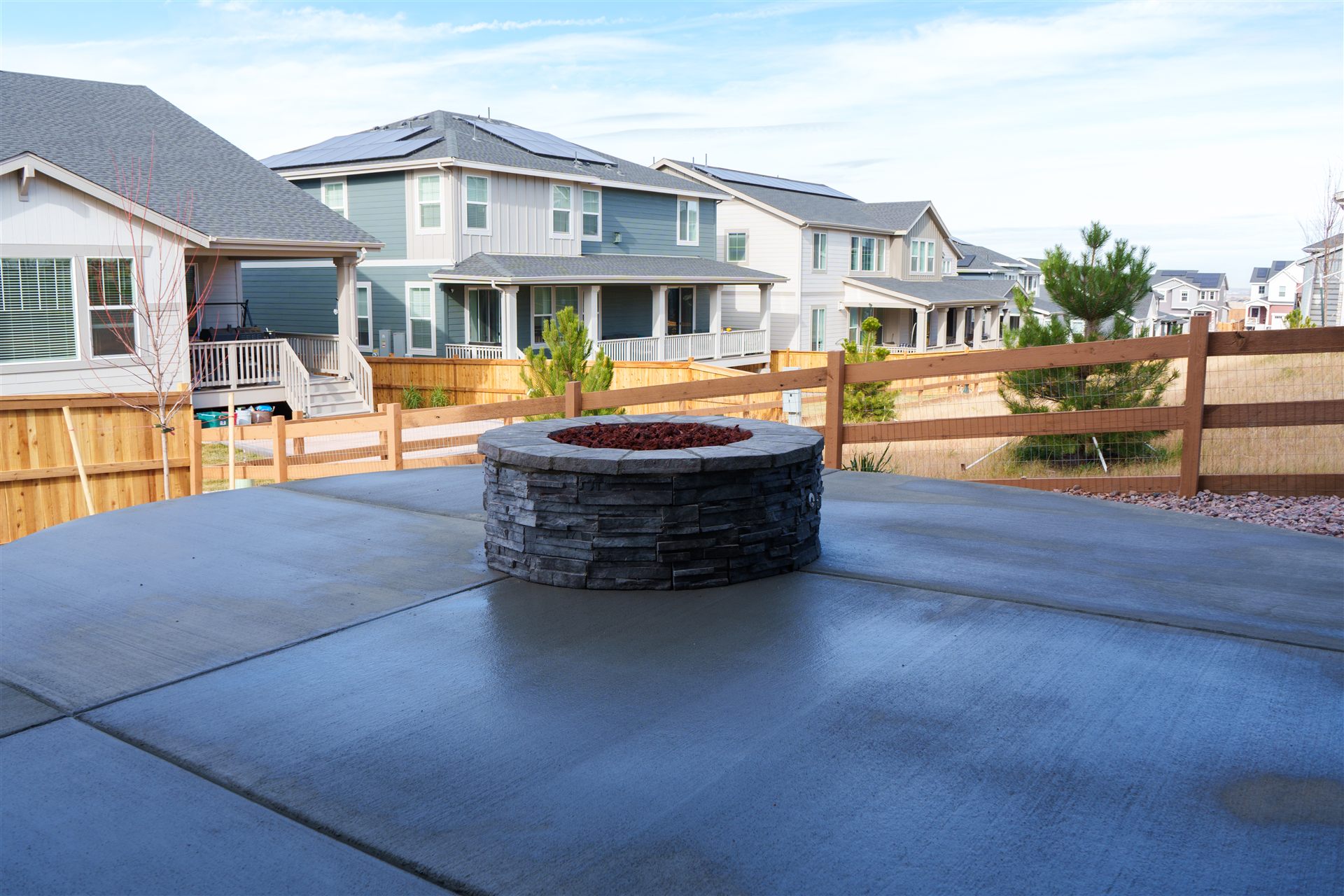 Round stone fire pit on a new concrete patio in Thornton, CO