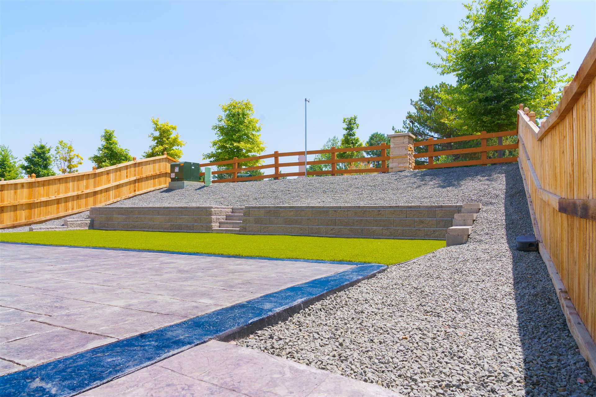 Stamped concrete patio, rock and block walls in a Thornton backyard