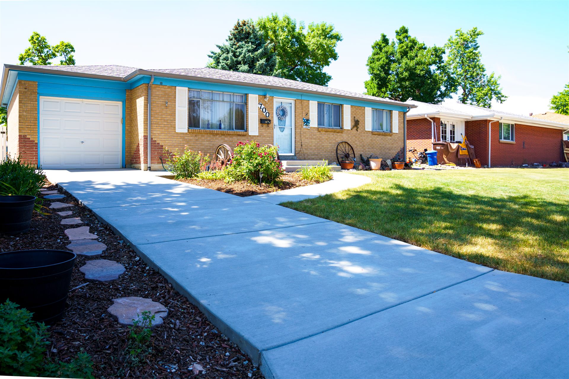 New concrete driveway and front walkway at a brick ranch home