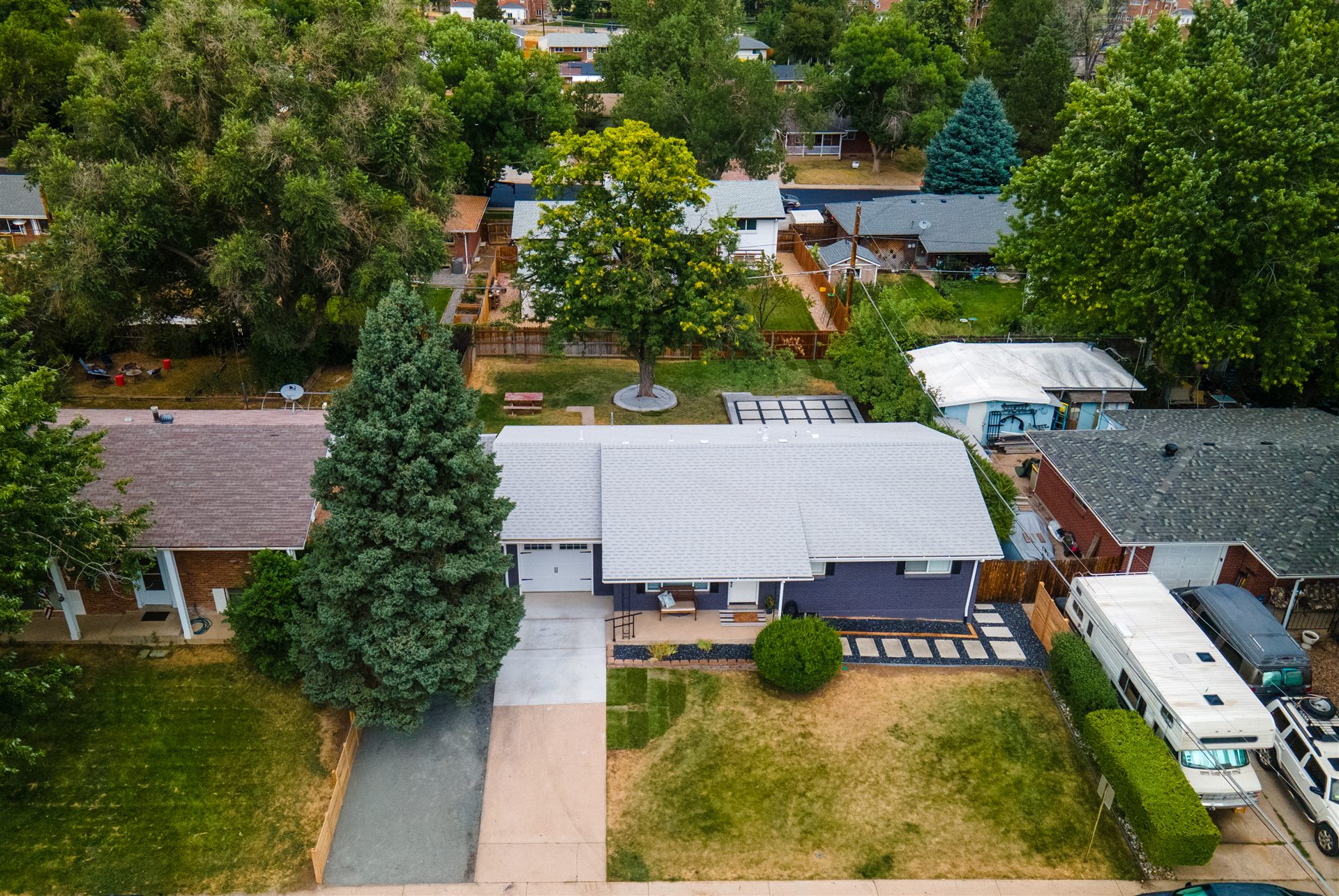 Aerial view of a raised concrete slab patio behind a brick ranch in Westminster